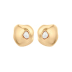 Organic-shaped eco-zinc alloy stud earrings with resin pearl centers and sterling silver posts on white background.