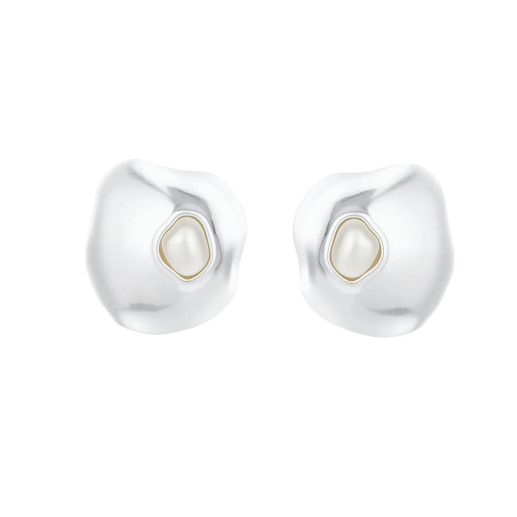 Organic-shaped eco-zinc alloy stud earrings with resin pearl centers and sterling silver posts on white background.