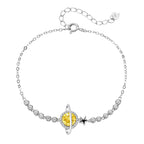 Sterling silver bracelet with yellow moissanite centerpiece in oval setting, crystal chain, and star charm on white background.