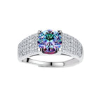 Sterling silver adjustable ring with brilliant round moissanite center stone and pavé diamond band showing rainbow fire