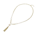 Long gold-plated necklace with freshwater pearls, chunky chain links, and flowing tassel pendant