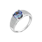 Sterling silver adjustable ring with brilliant round moissanite center stone and pavé diamond band showing rainbow fire