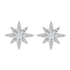 Sterling silver star-shaped stud earrings with brilliant moissanite center stones and pavé details on neutral background.