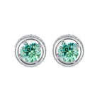 Round green moissanite stud earrings in sterling silver halo settings with brilliant sparkle on white background.