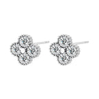 Dainty sterling silver quatrefoil stud earrings with four brilliant moissanite stones and center accent on white background.