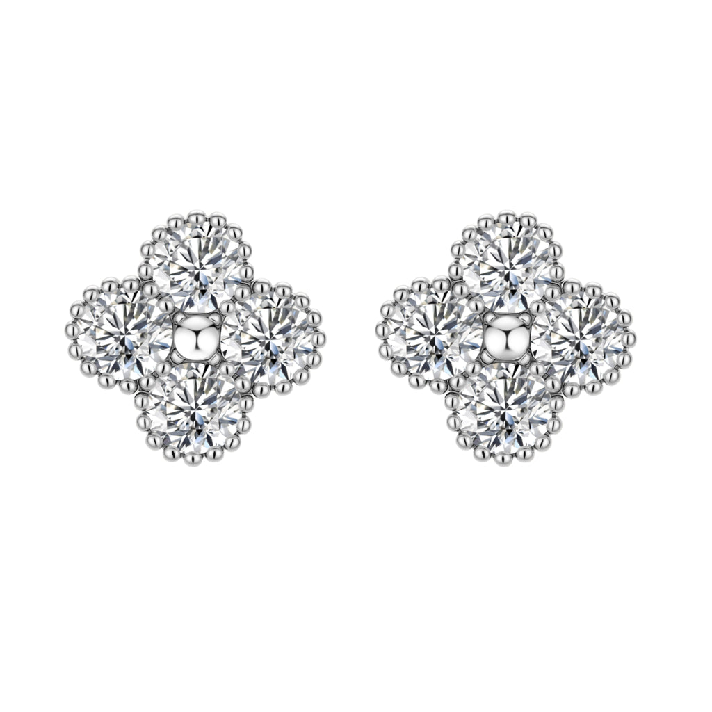 Dainty sterling silver quatrefoil stud earrings with four brilliant moissanite stones and center accent on white background.