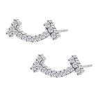 Curved sterling silver ear climbers with moissanite stones arranged in elegant arc shape on white background