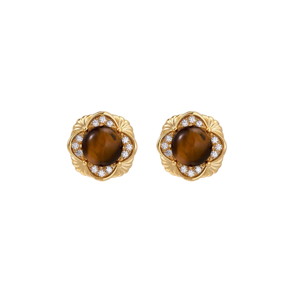 Gold-plated stud earrings with ornate floral frames surrounding cabochon tiger's eye stones and zirconia accents