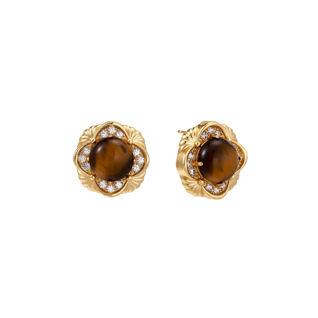 Gold-plated stud earrings with ornate floral frames surrounding cabochon tiger's eye stones and zirconia accents