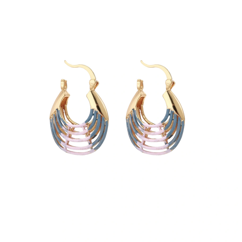 Gold hoop earrings with gradient blue-to-pink enamel in ribbed fan design on beige background