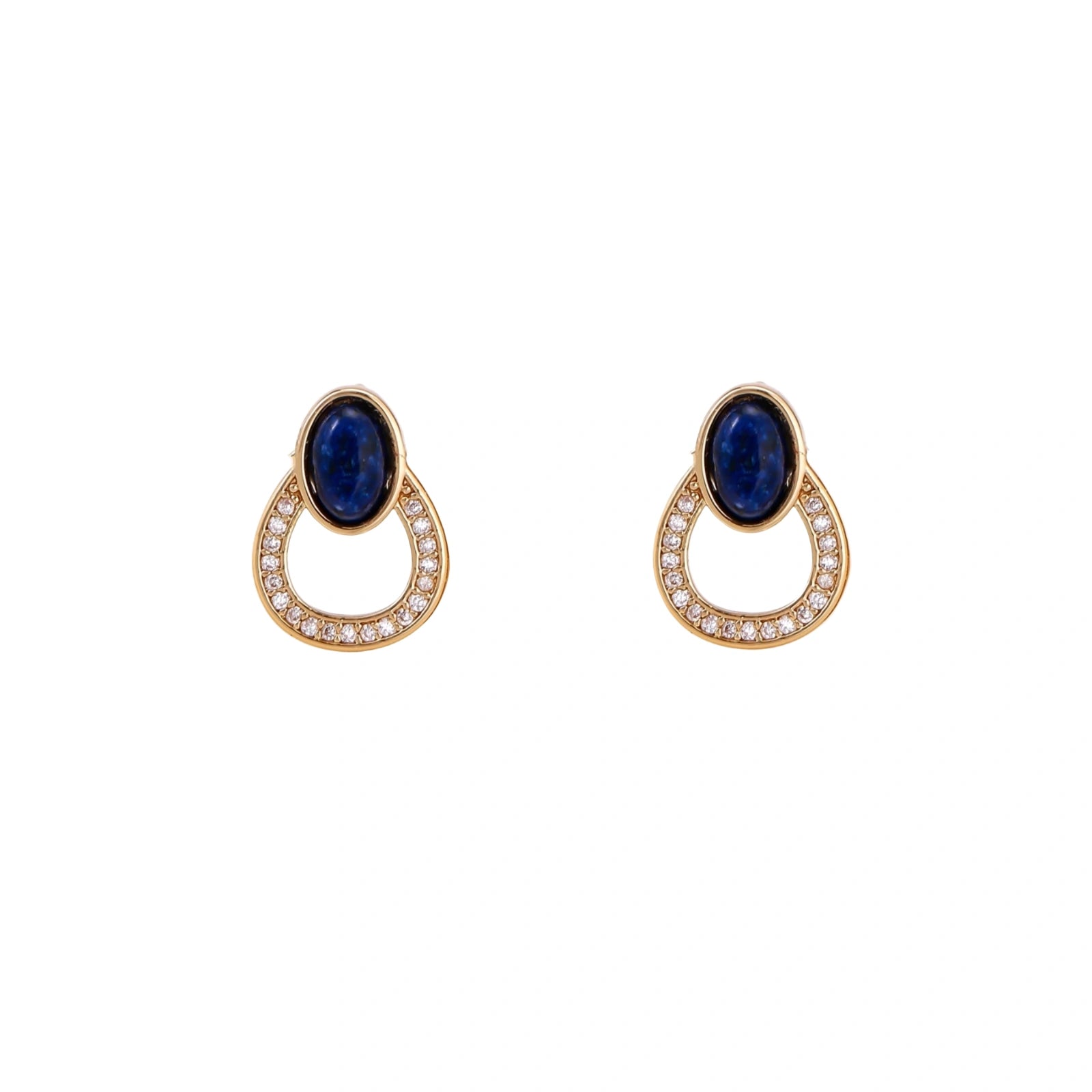 Gold drop earrings with oval lapis lazuli, crystal-paved frame, and iridescent mother-of-pearl teardrop on cream background