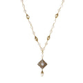 Y-shaped necklace with freshwater pearls, gold filigree stations, and ornate diamond-shaped centerpiece with pearl drop