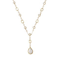 Long gold-plated necklace with alternating freshwater pearls and crystal bezels, featuring a large baroque pearl pendant