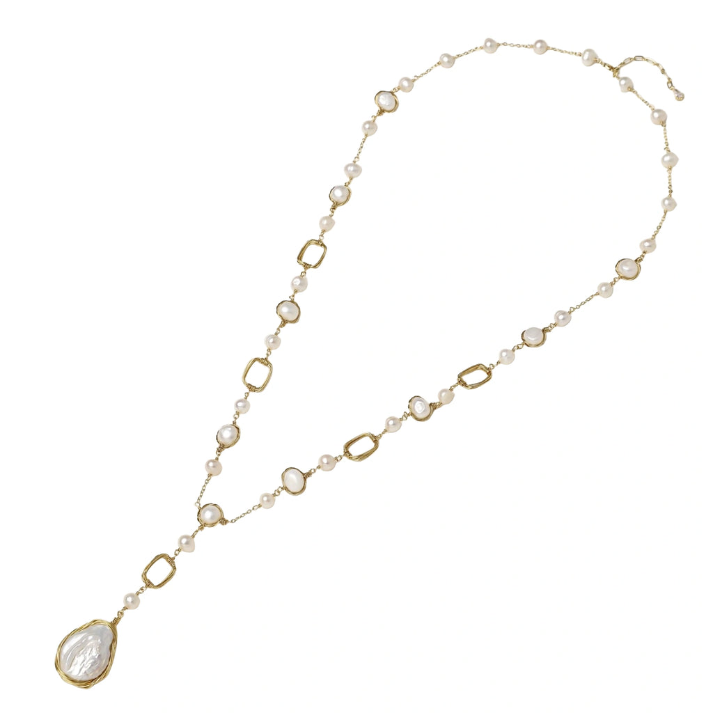 Long gold-plated necklace with alternating freshwater pearls and crystal bezels, featuring a large baroque pearl pendant
