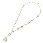 Long gold-plated necklace with alternating freshwater pearls and crystal bezels, featuring a large baroque pearl pendant