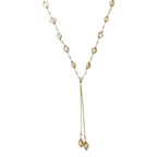 Adjustable gold lariat necklace with freshwater pearls nested in delicate cage settings and Y-shaped tassel drop