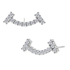 Curved sterling silver ear climbers with moissanite stones arranged in elegant arc shape on white background
