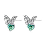 Sterling silver butterfly stud earrings with crystal wings and mint green center stones on cream background.
