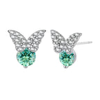 Sterling silver butterfly stud earrings with crystal wings and mint green center stones on cream background.