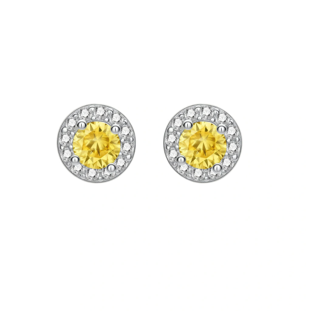 Dainty sterling silver stud earrings with yellow moissanite center stones surrounded by white halo stones