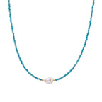 Delicate gold vermeil necklace with teal apatite beads and freshwater pearl on white background.