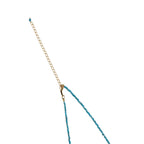 Delicate gold vermeil necklace with teal apatite beads and freshwater pearl on white background.