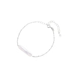 Minimalist bracelet with iridescent baroque pearl on rhodium-plated sterling silver chain against cream background