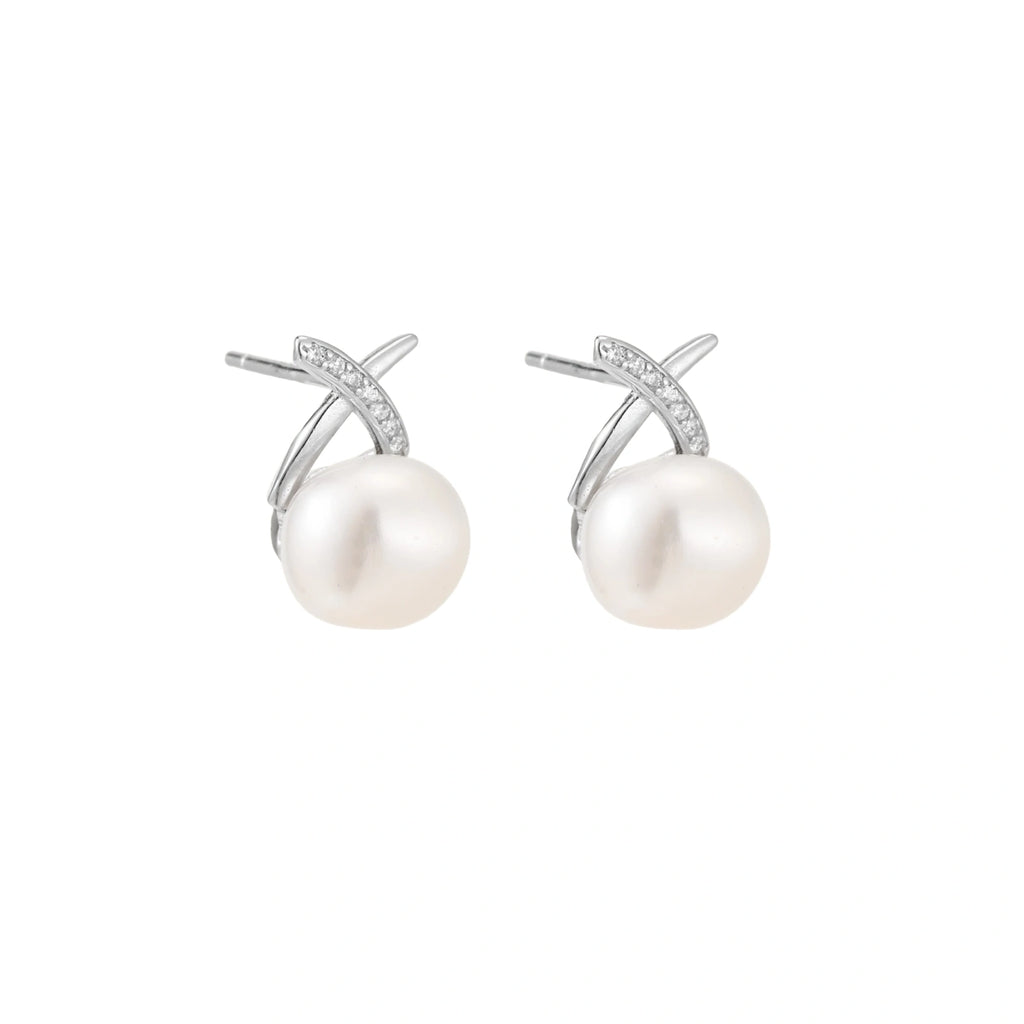Rhodium-plated silver stud earrings with sparkling X design above lustrous round freshwater pearls on white background.