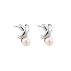 Rhodium-plated silver earrings with twisted X design and freshwater pearl drops on beige background