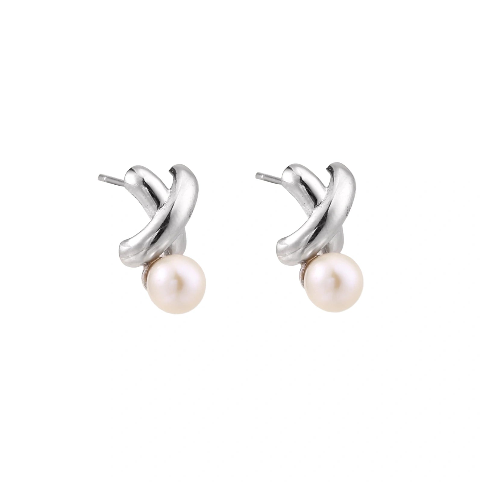 Rhodium-plated silver earrings with twisted X design and freshwater pearl drops on beige background
