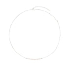 Delicate sterling silver chain necklace with small freshwater pearls arranged in a curved smile arc on cream background.