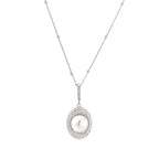 Oval sterling silver pendant with crystal halo surrounding a white freshwater pearl on delicate chain