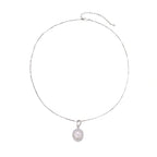 Oval sterling silver pendant with crystal halo surrounding a white freshwater pearl on delicate chain