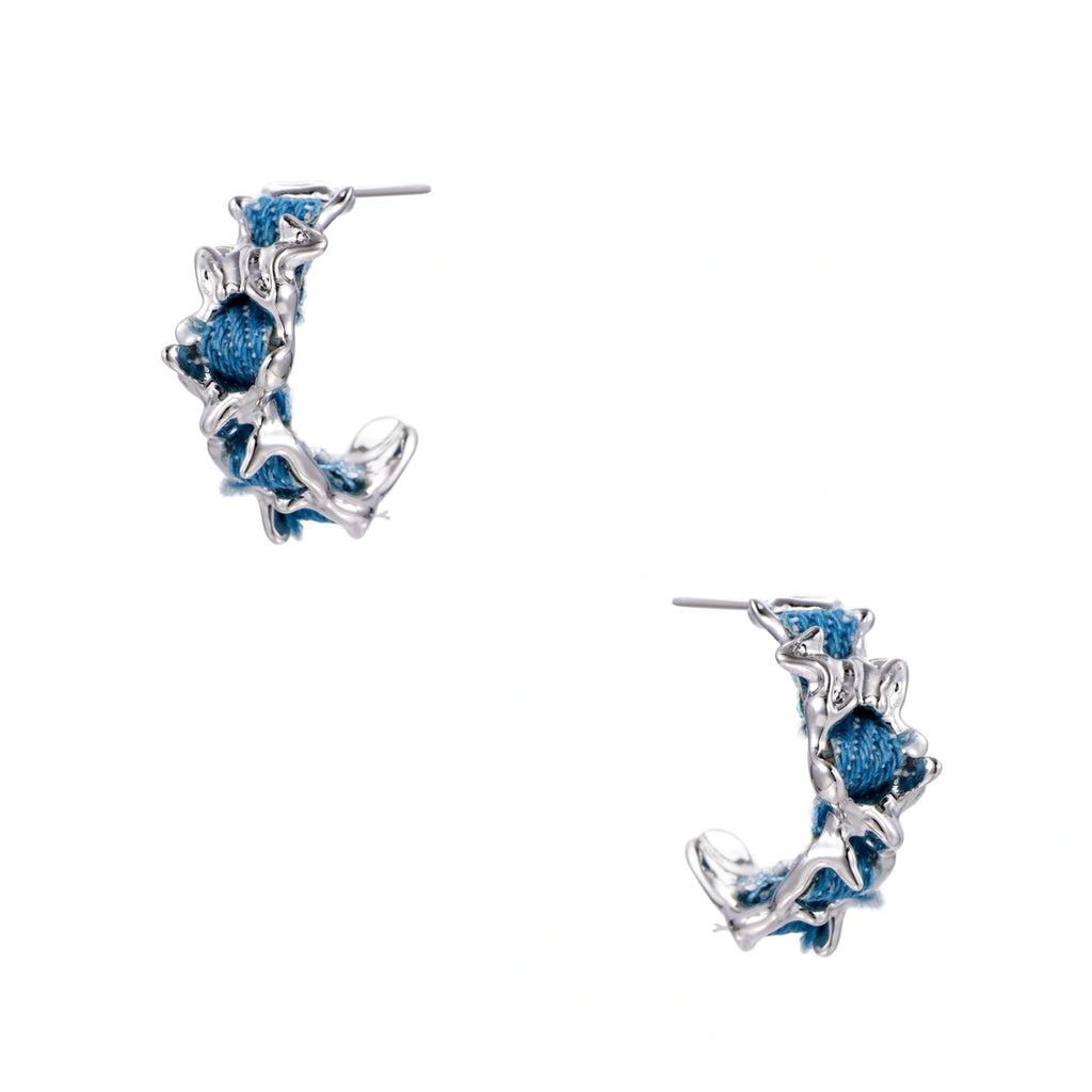 White gold plated hoop earrings with woven blue denim fabric through organic branch-like metal framework