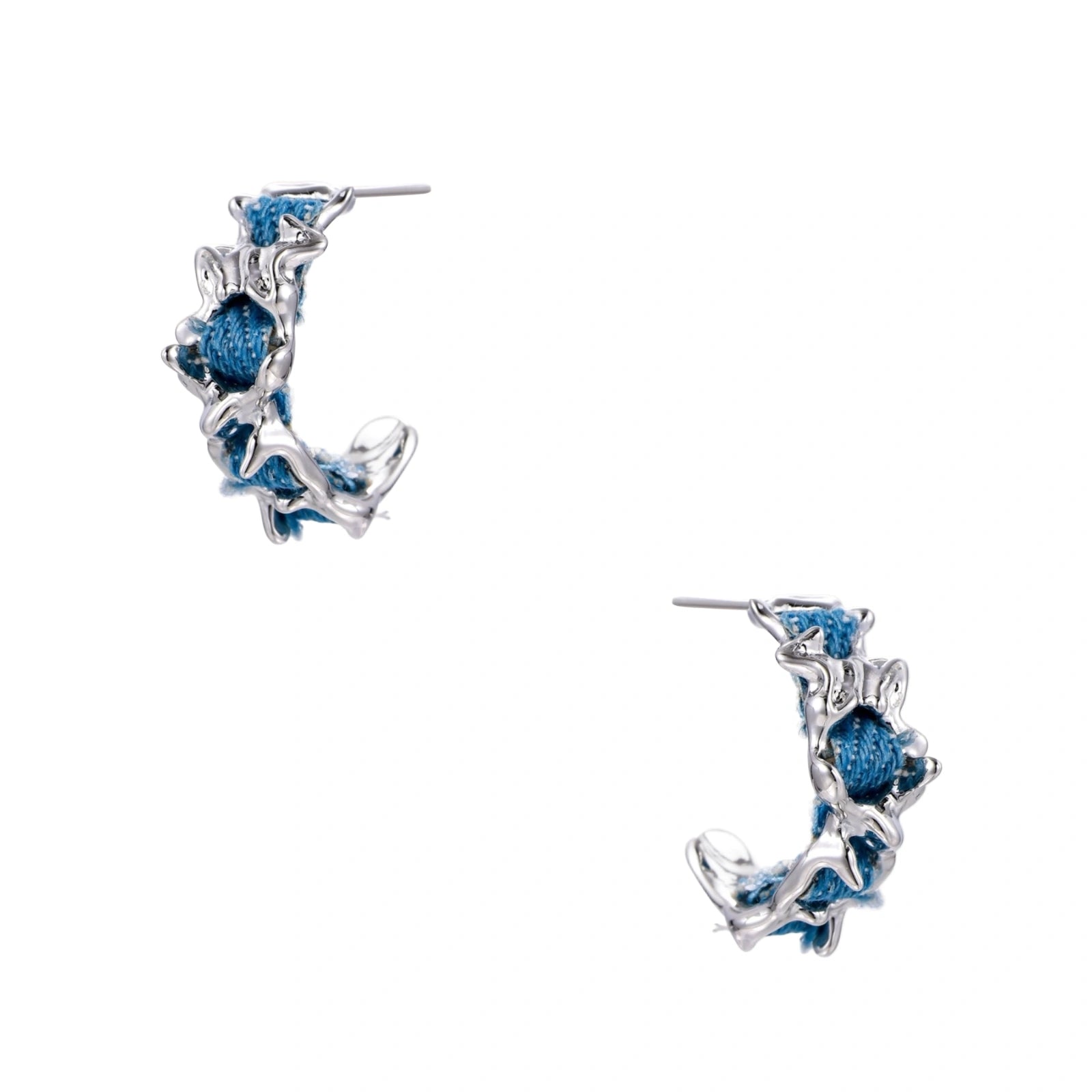 White gold plated hoop earrings with woven blue denim fabric through organic branch-like metal framework