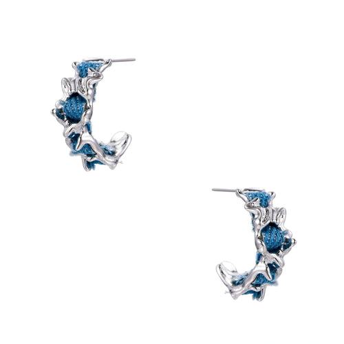 White gold plated hoop earrings with woven blue denim fabric through organic branch-like metal framework