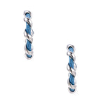 White gold-plated hoops intertwined with blue denim fabric in a twisted rope design on cream background.