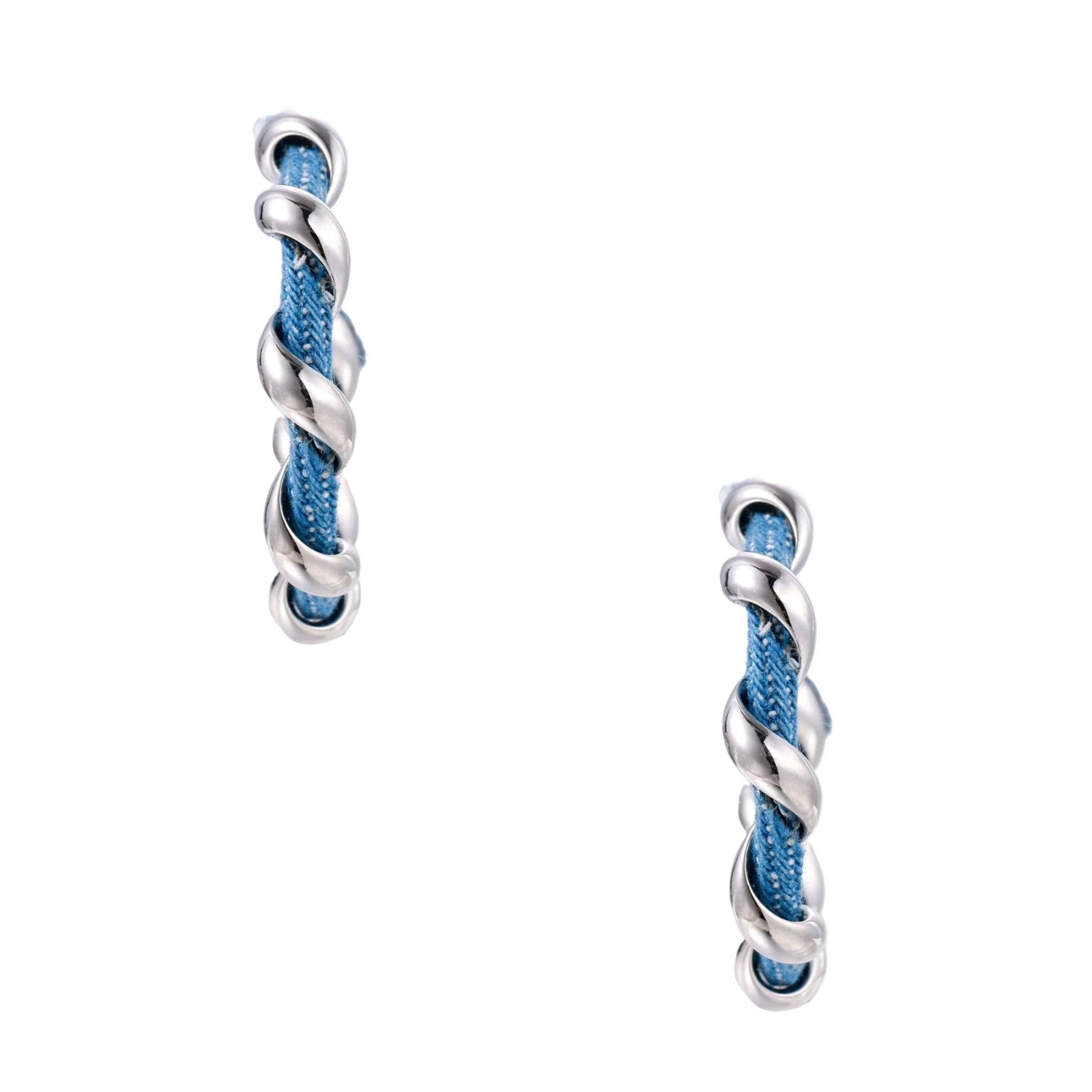 White gold-plated hoops intertwined with blue denim fabric in a twisted rope design on cream background.