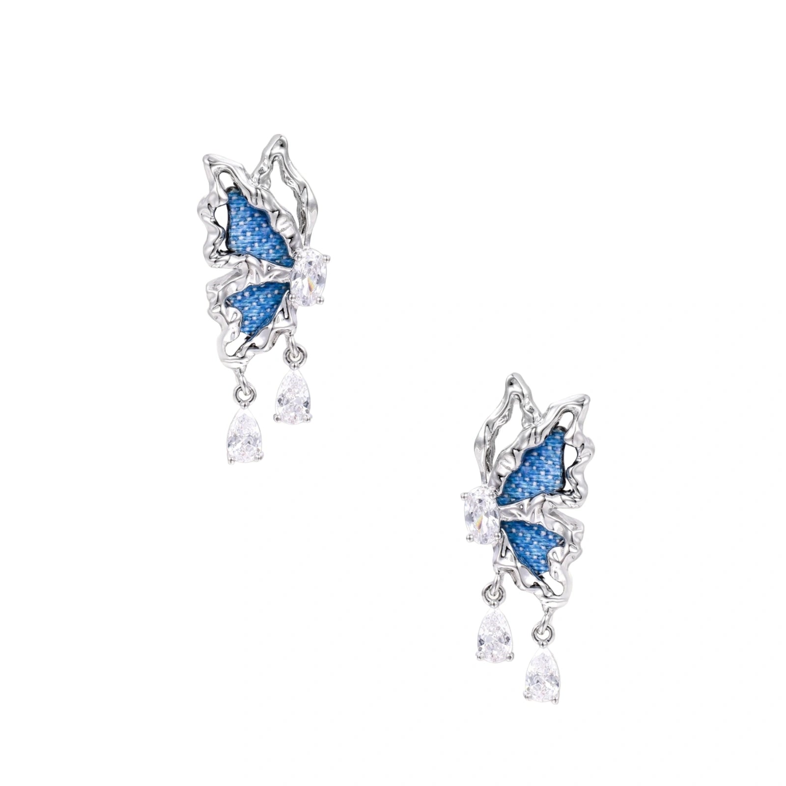 Silver butterfly earrings with blue denim fabric wings and dangling teardrop crystals on cream background