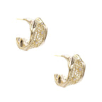 Gold-plated sculptural hoop earrings with geometric lattice centerband and sparkling zirconia on white background.