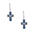 Silver huggie earrings with blue enamel cross charms featuring bat wings and heart-shaped crystal center