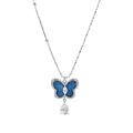 Silver-toned butterfly pendant with blue denim fabric inlay and teardrop crystal on dual-chain necklace