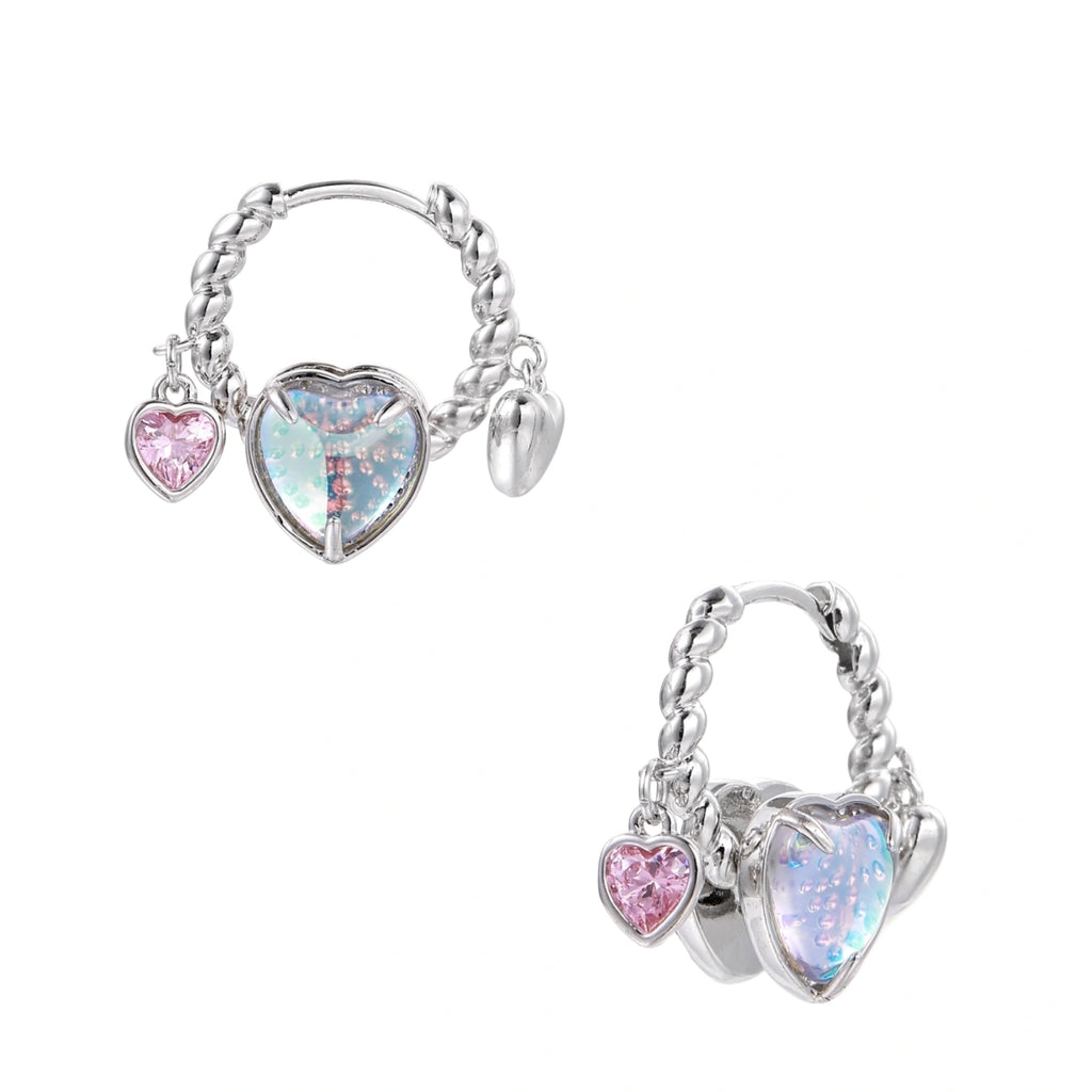 Silver chain hoop earrings with iridescent opal heart charms and pink zirconia accents on white background