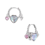 Silver chain hoop earrings with iridescent opal heart charms and pink zirconia accents on white background