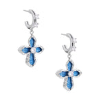 Silver hoops with denim-inlaid cross charms and clear crystals on beige background