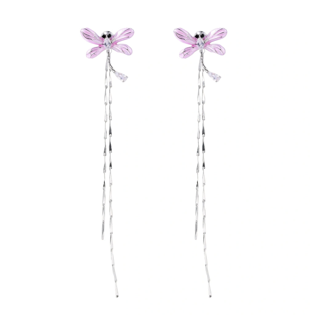 Long drop earrings with translucent lavender enamel dragonfly wings and white gold plated segmented bodies on white background