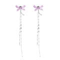 Long drop earrings with translucent lavender enamel dragonfly wings and white gold plated segmented bodies on white background