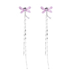 Long drop earrings with translucent lavender enamel dragonfly wings and white gold plated segmented bodies on white background