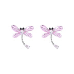Long drop earrings with translucent lavender enamel dragonfly wings and white gold plated segmented bodies on white background