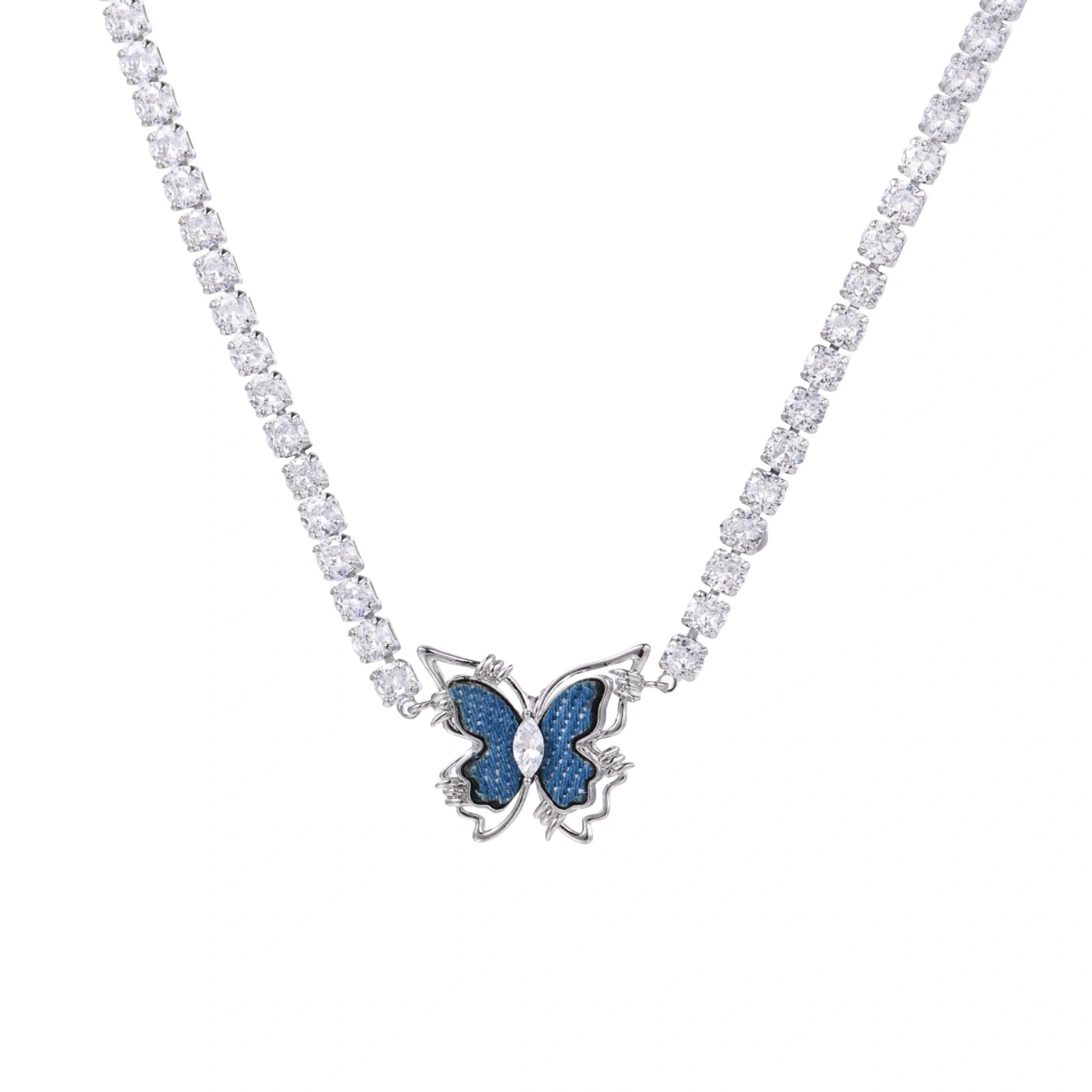 White gold plated tennis necklace with blue denim butterfly pendant and clear zirconia stones on cream background